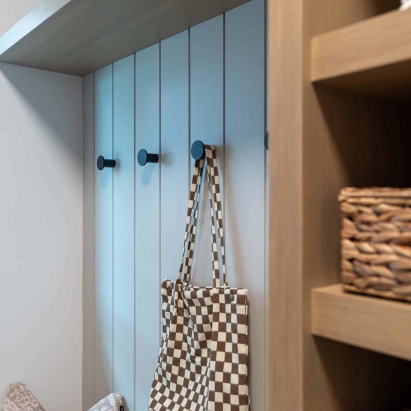Hooks, slats, and woven baskets—entryway calm, styled to perfection.